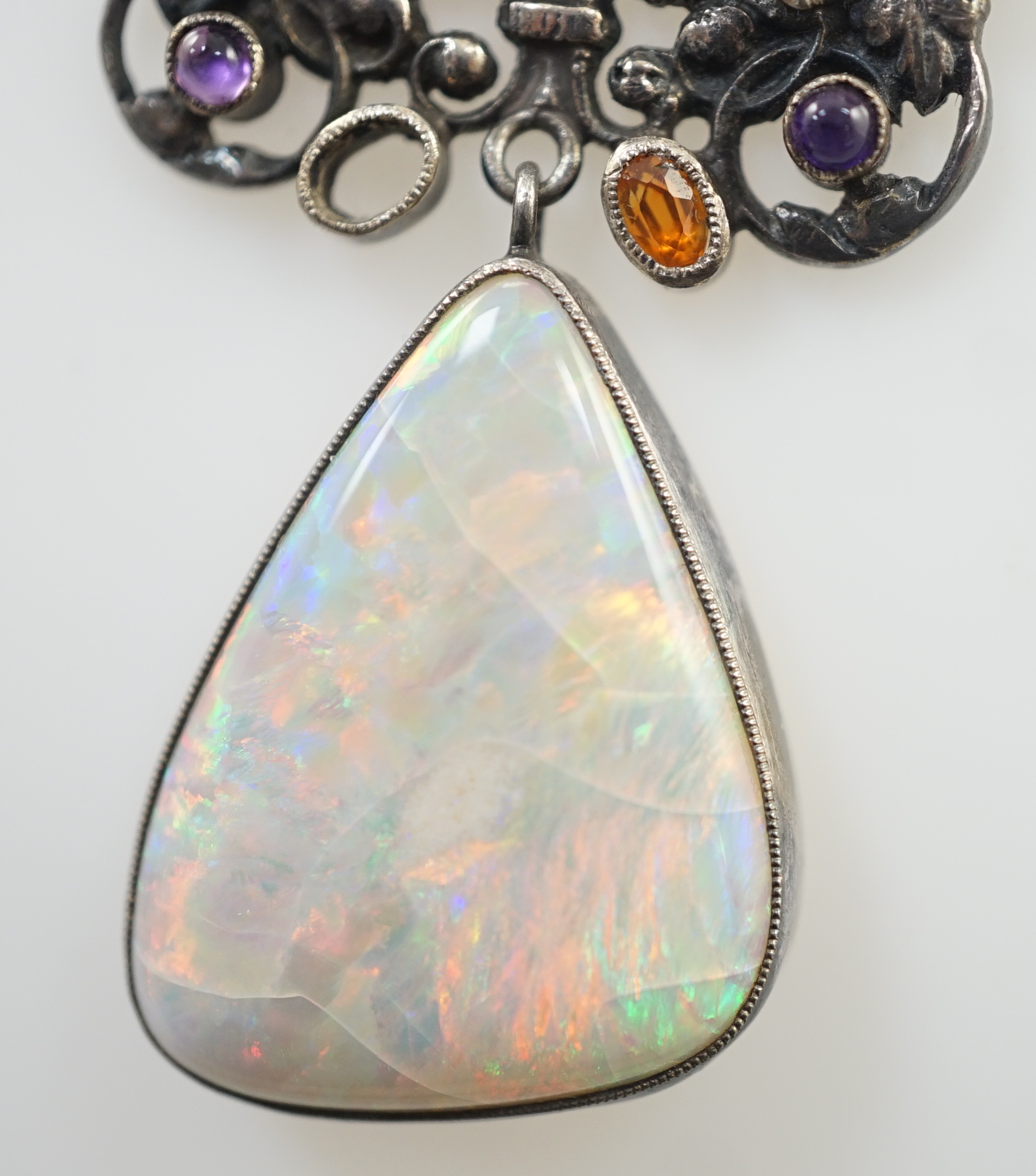 An early 20th century silver, white opal and cabochon gem cluster set drop pendant necklace, in the manner of Sibyl Dunlop